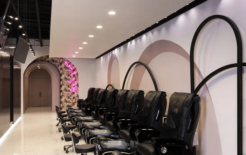Pedicure lounge beneath painted arch murals