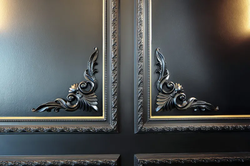 Carved ornament on a black molded panel