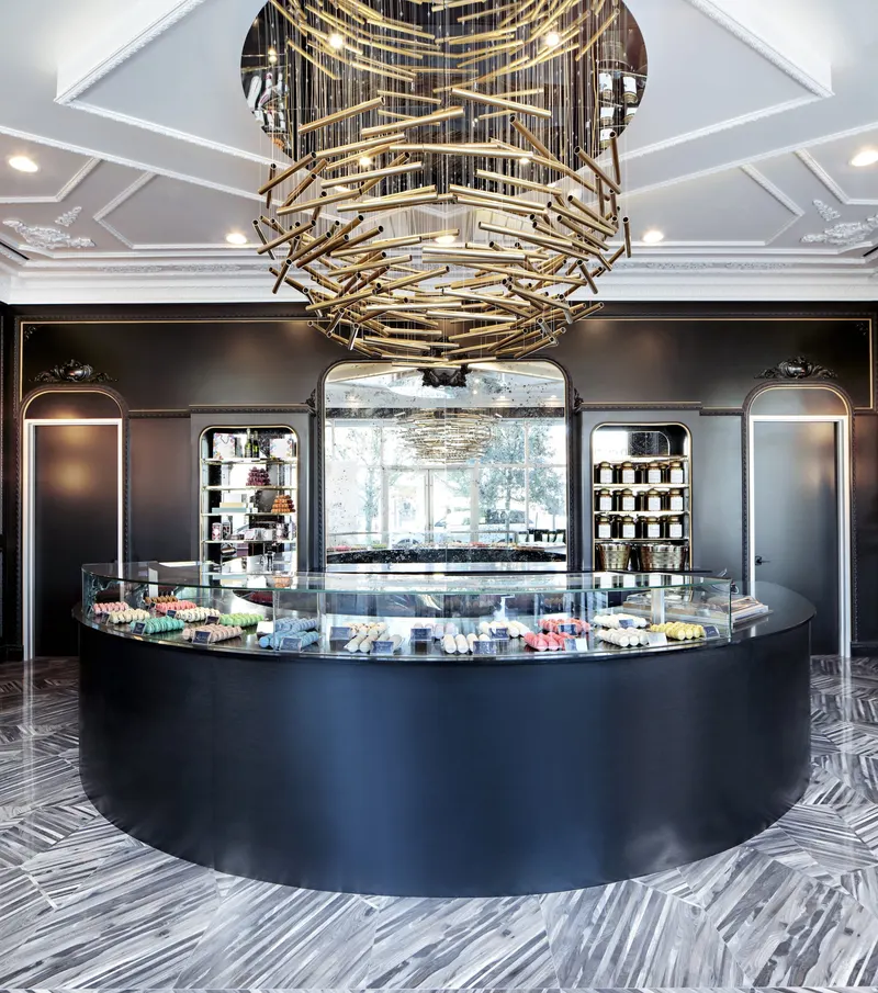Curved display counter beneath the chandelier