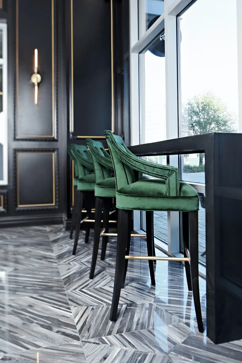 Green velvet stools at the window bar