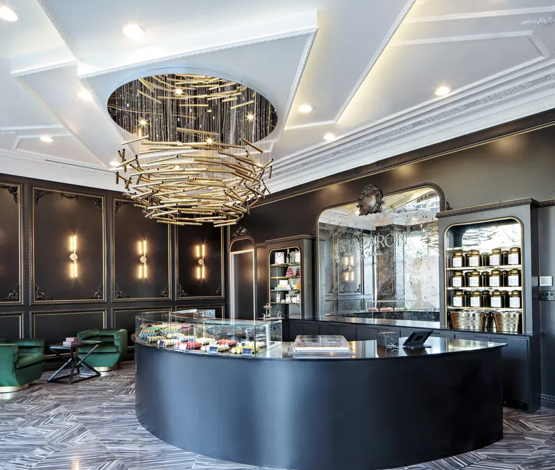 Sculptural gold chandelier at Macaron By Patisse, built by Capital Builders