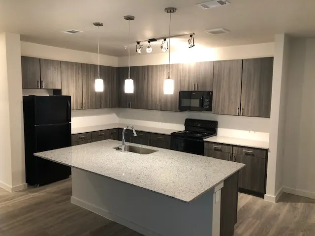 Apartment kitchen with island and pendant lights