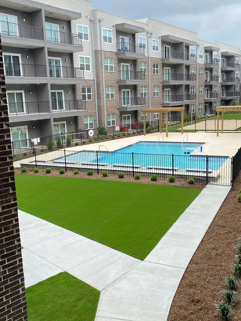 Resort pool and turf courtyard between buildings