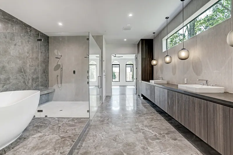 Spa bath with freestanding tub, stone walls and clerestory windows