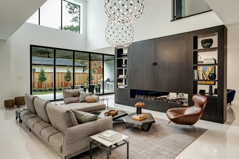 Double-height family room with a see-through fireplace and walnut built-ins