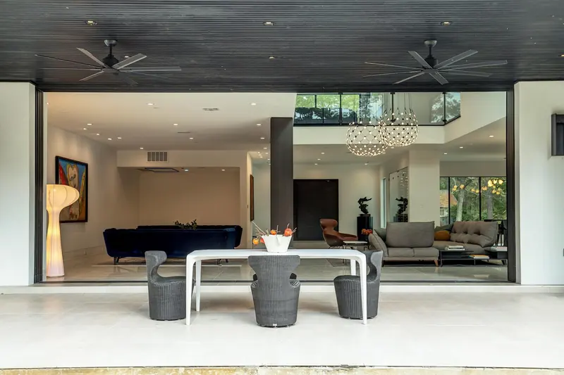 Covered patio opening into the family room through pocketing glass walls