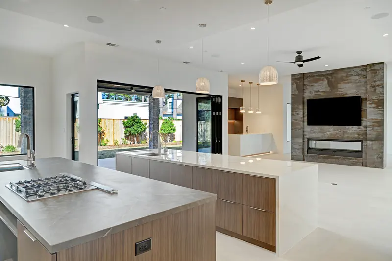 Kitchen with two islands facing the stone fireplace wall