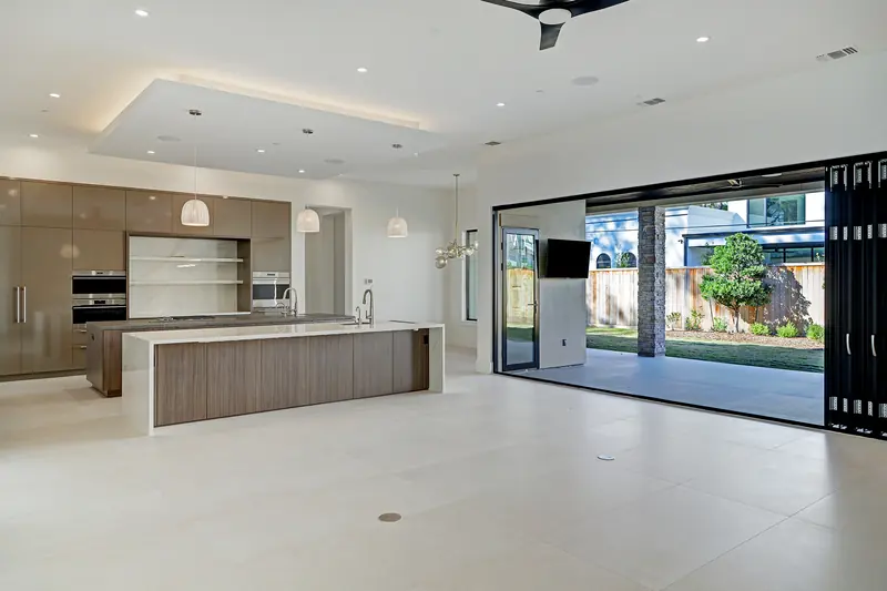 Open kitchen connecting to the covered patio through folding glass doors