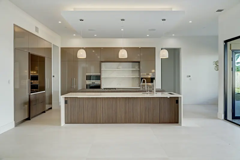 Kitchen with walnut island, quartz counters and paneled appliances