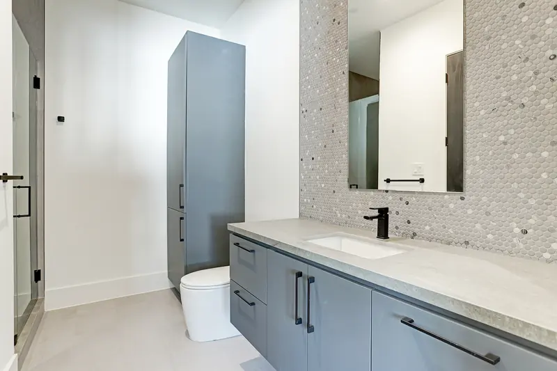 Secondary bath with mosaic tile wall and floating vanity