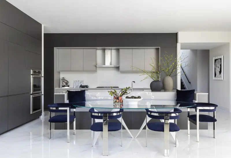 Dining room open to a modern kitchen with a marble island