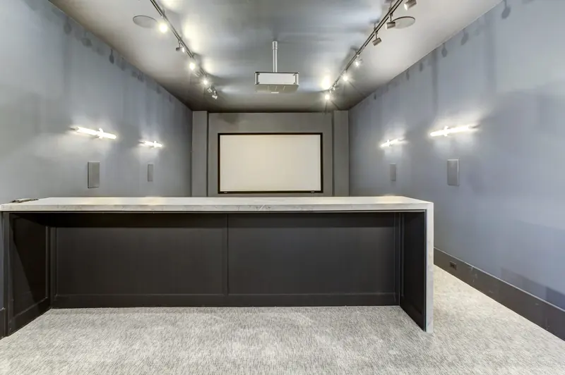 Private media room with projection screen and theater lighting