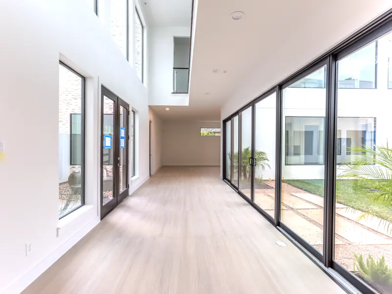 Glass corridor with sliding doors along the courtyard