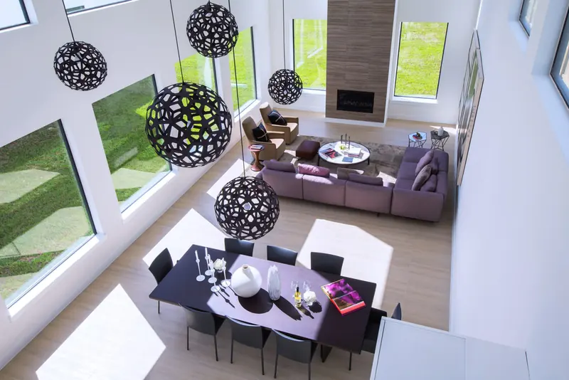 Living and dining spaces seen from the second-floor bridge