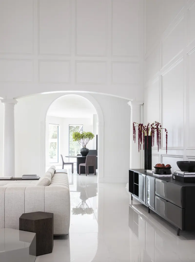 Paneled gallery with arched doorways leading to the living room