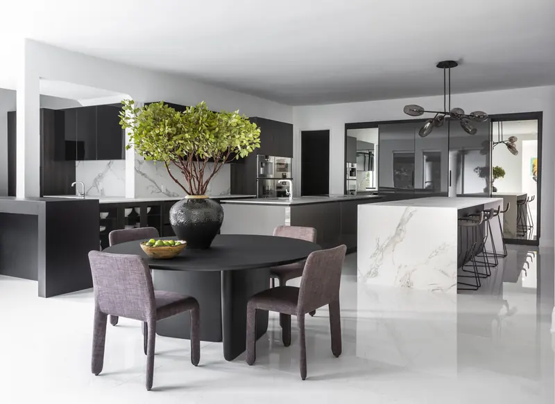 Breakfast table beside the kitchen's marble waterfall island