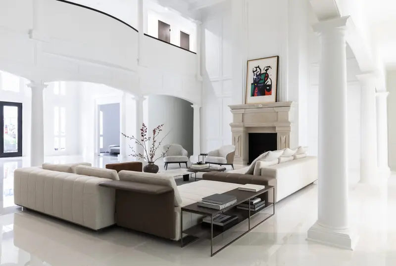 Living room colonnade with limestone fireplace and modern sectional