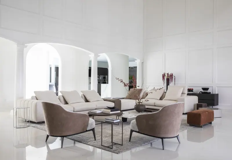 Family room with arched windows and paneled walls