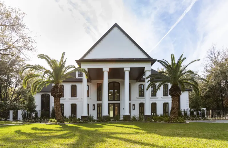 Front elevation with full-height columns flanked by date palms