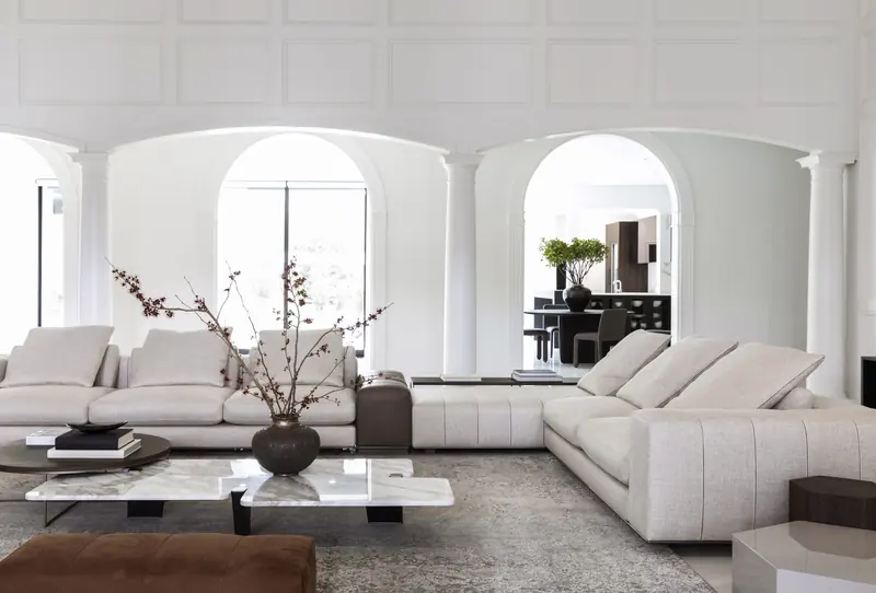 Living room with a run of arched windows and plaster columns