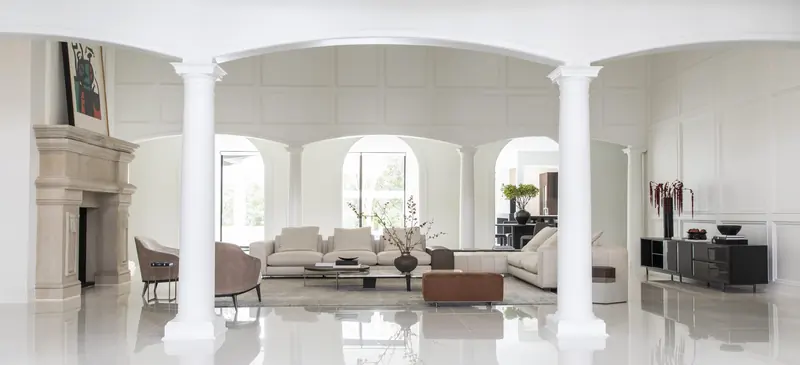 Formal living room framed by arched openings and classical columns