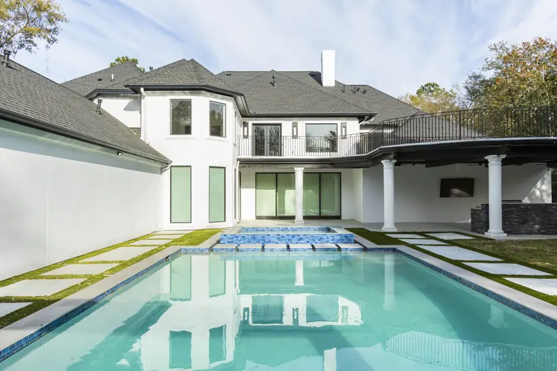Pool and covered loggia across the back of the home