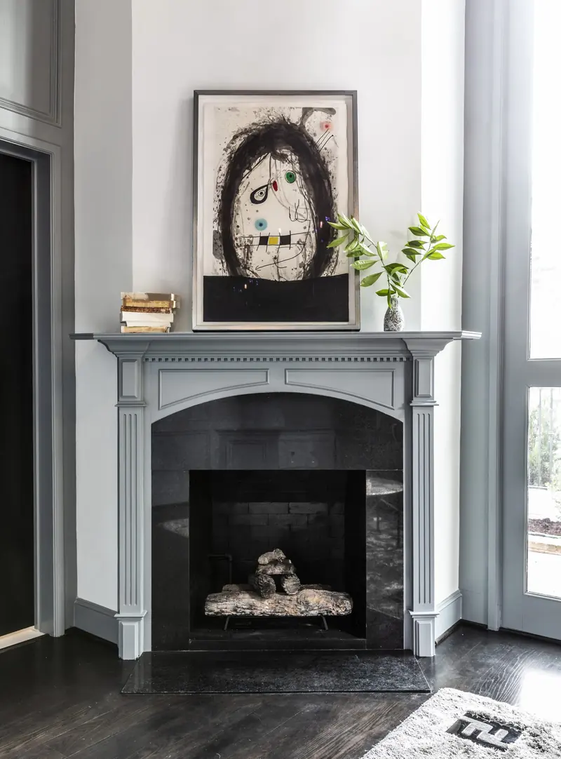 Study fireplace with painted mantel and framed art