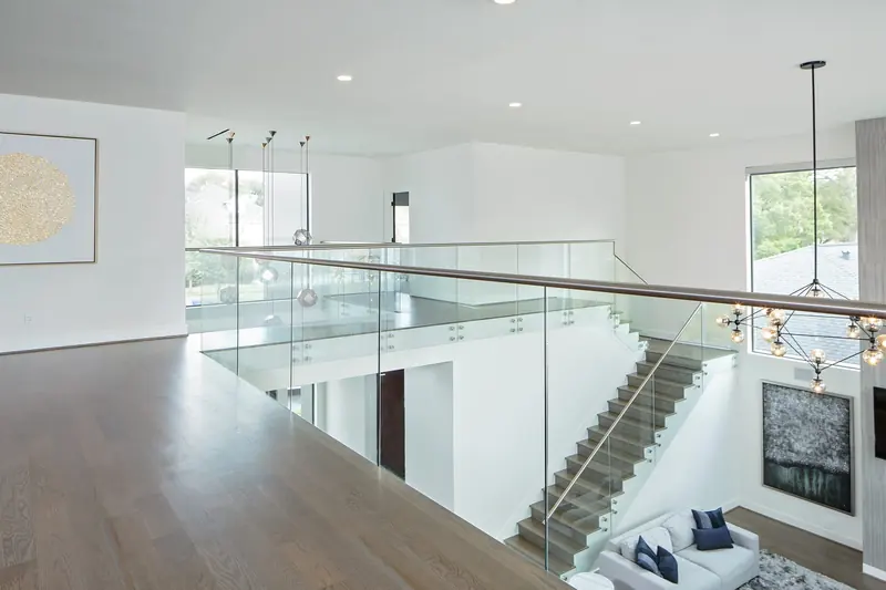 Upper landing with glass railings overlooking the living room