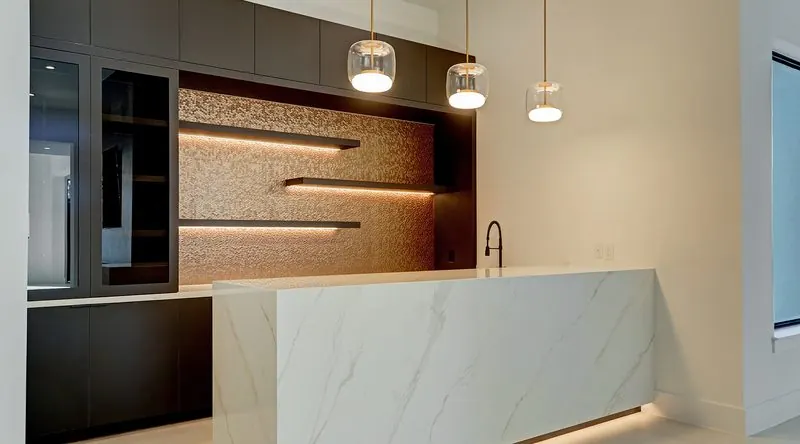 Custom kitchen with backlit marble island in the Bunker Hill residence